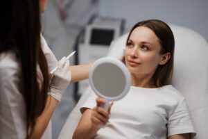 Cosmetologist consulting with a patient about facial surgery and contouring procedures to enhance facial symmetry and rejuvenation